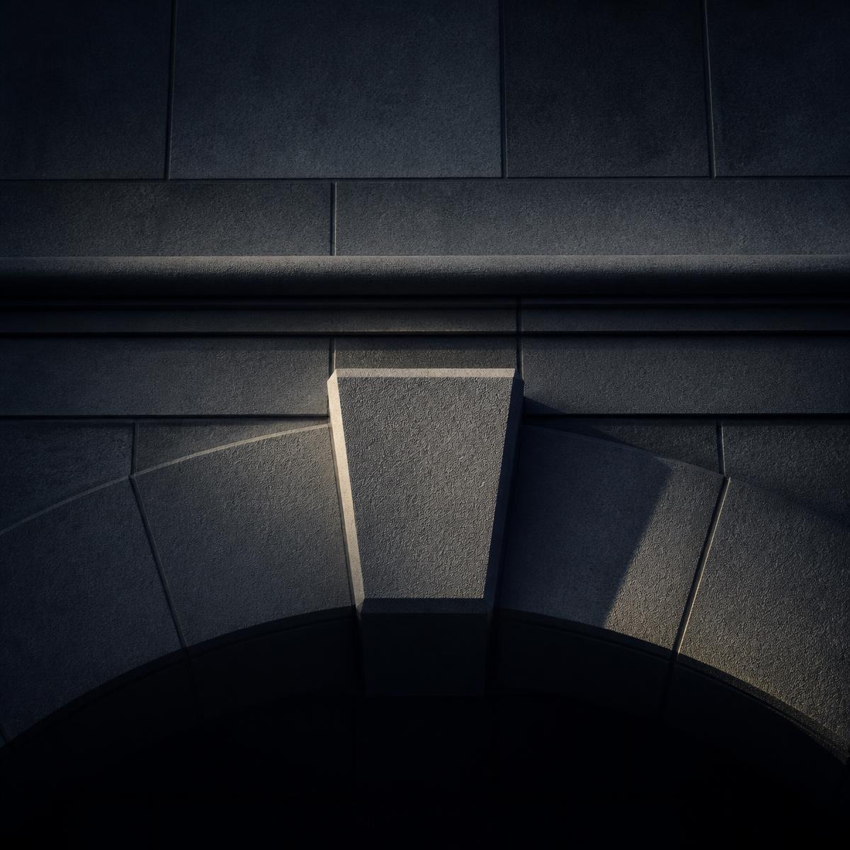 Architectural detail of a stone keystone locking an arch